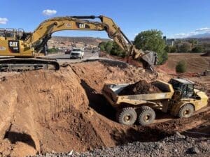 SR-18 Bluff street pedestrian tunnel excavator and haul truck