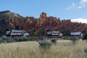 Sunroc Dump Trucks lined up to Delivery Hot Asphalt on SR-12 Near Bryce Canyon Utah