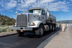 Sunroc spray paver puts down a tack coat is a thin bituminous liquid asphalt