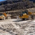 Haul trucks transferring raw gypsum